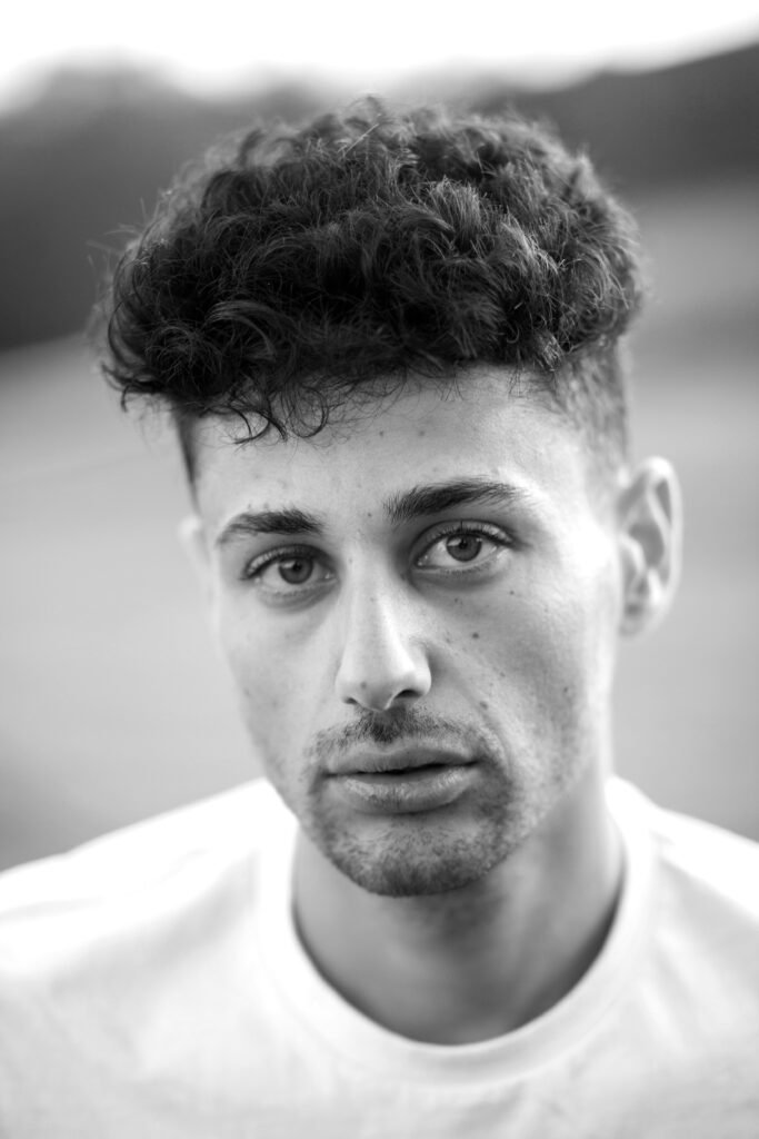 Low Skin Fade with Curly Top